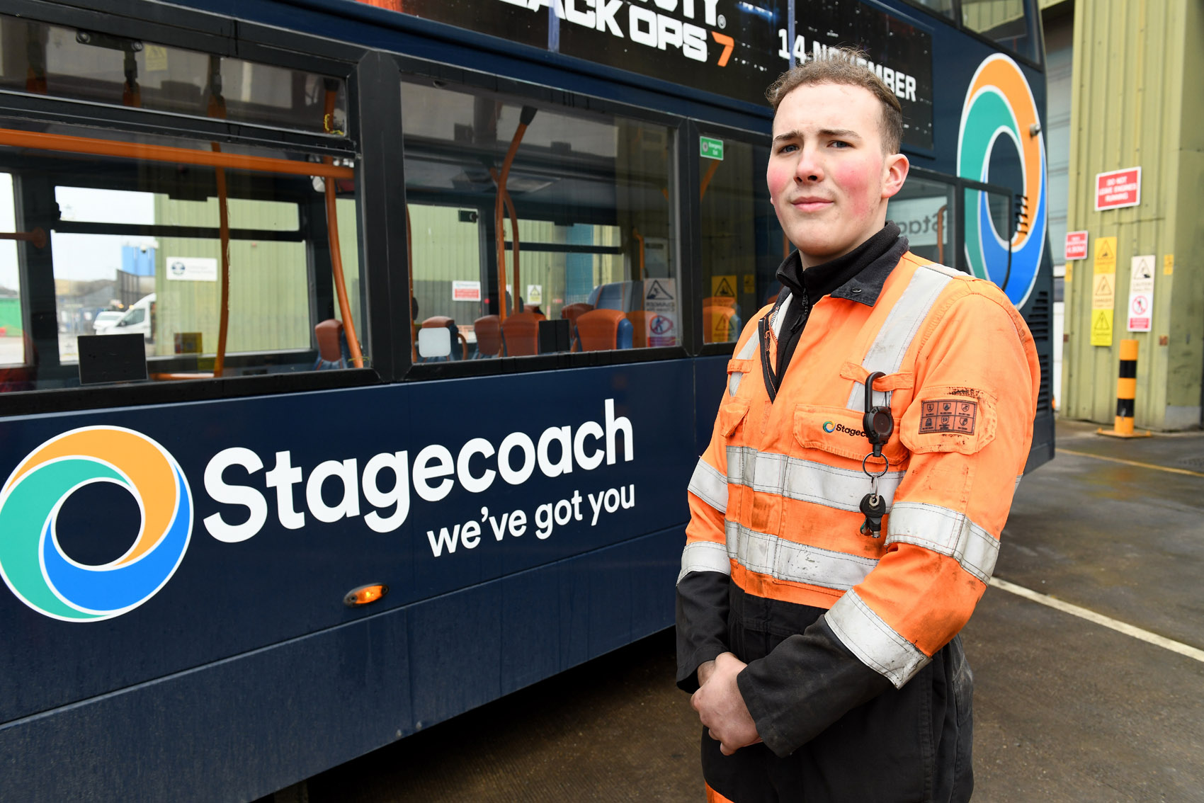 A photo of Adam Flowers in front of a branded bus at Stagecoach East Midlands Foster Street Depot.