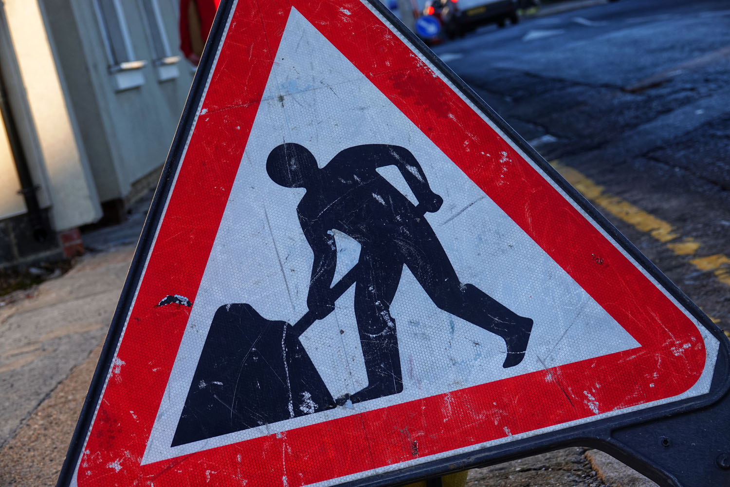 An image of a red and white triangle sign promoting road works.