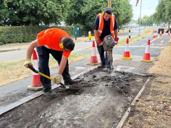 Operatives repairing a pothole on an off-road cycle lane, on Leads Road.